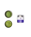 A tin container of Wazuka Tea Nakai Superior next to a bowl and a dish of matcha powder